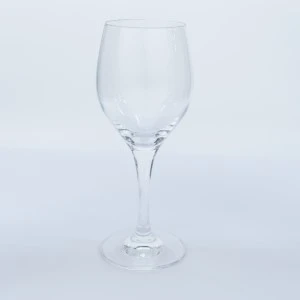 Clear wine glass with long stem and rounded bowl on white background for event rentals.