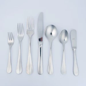 Silver stainless steel flatware set with multiple forks, knives, and spoons on white background.