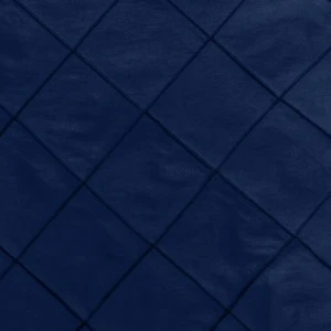 Navy blue pintuck fabric with diamond-shaped textured pattern for elegant event linen rental.