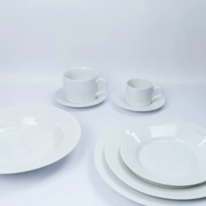 White ceramic dinnerware set with two coffee cups, saucers, and stacked plates.