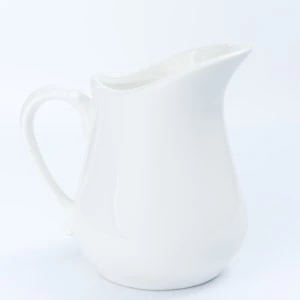 White ceramic pitcher with curved spout and handle for elegant event tableware rentals.