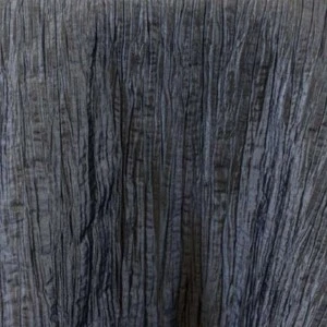 Gray crinkled fabric linen with deep vertical texture and shadowy dimensional ripples.