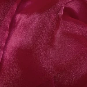 Deep burgundy velvet fabric with rich, lustrous sheen and soft textured surface for elegant event linen rental.