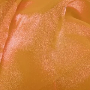Shimmery golden-orange fabric with soft folds and subtle metallic texture for event rentals.
