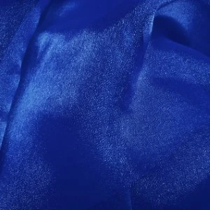 Royal blue shimmery satin fabric with soft folds and metallic sheen for elegant event linen rentals.