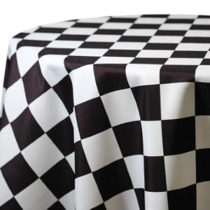 Black and white checkered tablecloth with crisp diamond pattern draped elegantly.