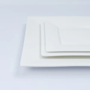 Stacked white rectangular placemats with clean, layered edges on minimalist background.