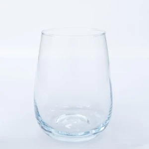 Clear glass stemless wine tumbler with smooth curved sides and rounded bottom.