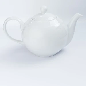 White ceramic teapot with smooth rounded design and delicate curved spout and handle.