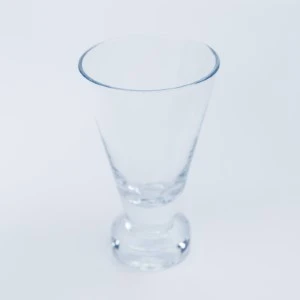 Clear stemless martini glass with thick base and tapered sides for event glassware rental.