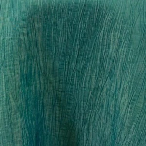 Teal textured fabric with vertical rippled lines and wrinkled surface for event linen rental.
