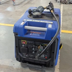 Blue and black portable inverter generator with control panel, sitting on concrete floor.