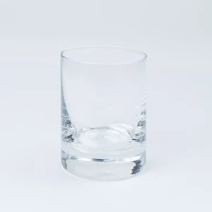 Clear glass whiskey tumbler with thick base and smooth sides for event barware rentals.
