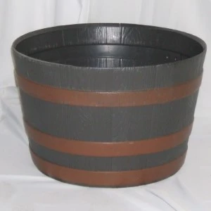 Dark gray and rust-colored wooden barrel-style planter with horizontal bands for event decor.