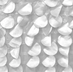 White textured fabric backdrop with overlapping semi-circular pleated panels creating dimensional waves.