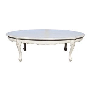 Antique white oval coffee table with curved cabriole legs and distressed wooden surface for event staging.