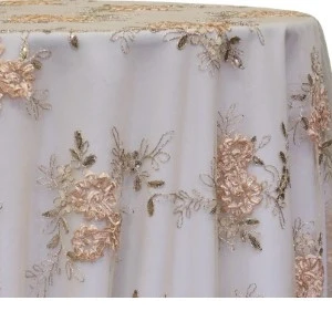 Blush pink floral lace tablecloth overlay with delicate embroidered roses on soft white fabric.