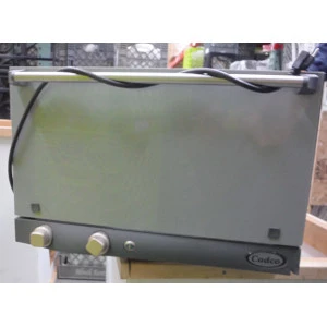 Stainless steel catering warmer with gray metallic finish and control knobs on rental equipment table.