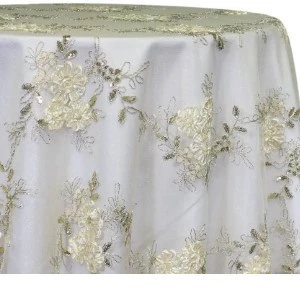 White tablecloth with soft gold and ivory floral lace overlay, featuring delicate embroidered floral pattern and.