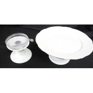 Two white ceramic cake stands in different sizes with raised pedestals and flat round surfaces.