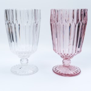 Two vintage-style goblets in clear and soft pink glass with ridged texture on stemmed base.