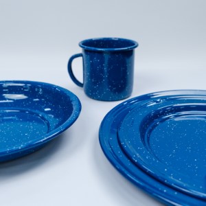 Vintage blue speckled enamelware set with plates and mug on white surface.