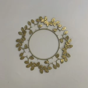 Gold floral wreath with delicate metallic leaves arranged in a circular frame against a neutral background.
