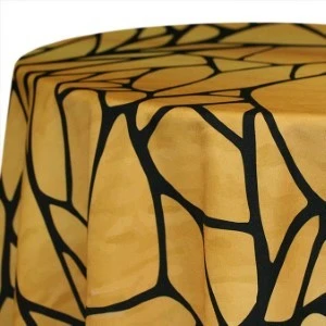 Golden yellow spandex tablecloth with dramatic black linear fracture pattern stretches smoothly over curved.