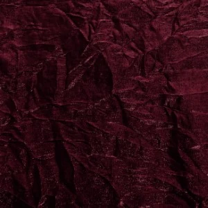 Deep red wrinkled fabric with soft textured surface and delicate creased appearance.