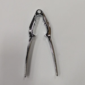A silver lobster cracker utensil