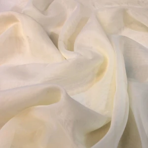 Sheer cream draped fabric with elegant folds and delicate translucent texture